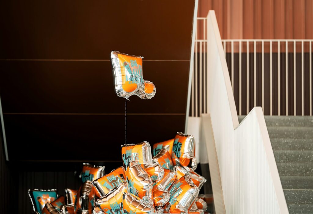 Balloons rest atop some stairs.