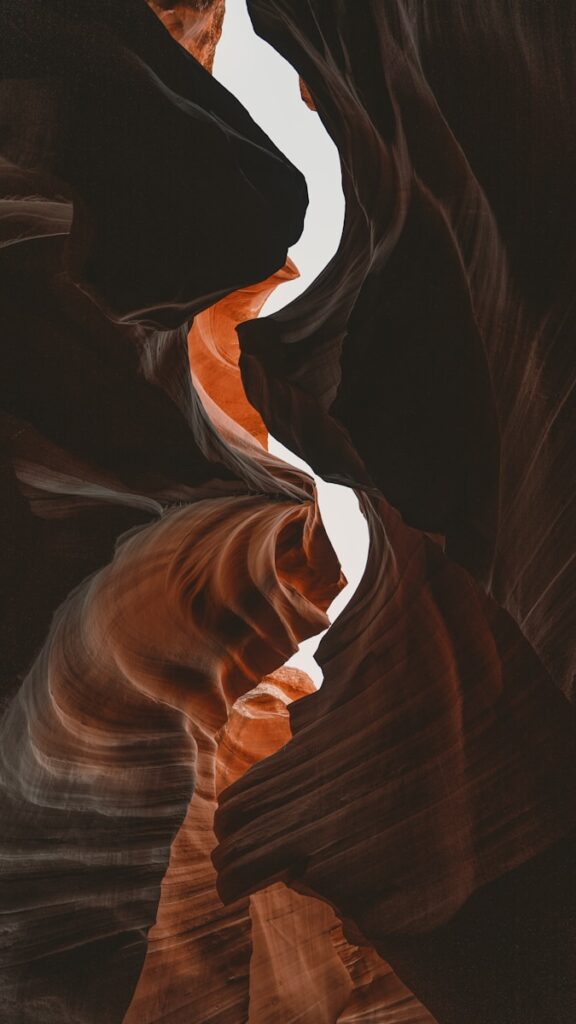 A painting of a river flowing through a canyon